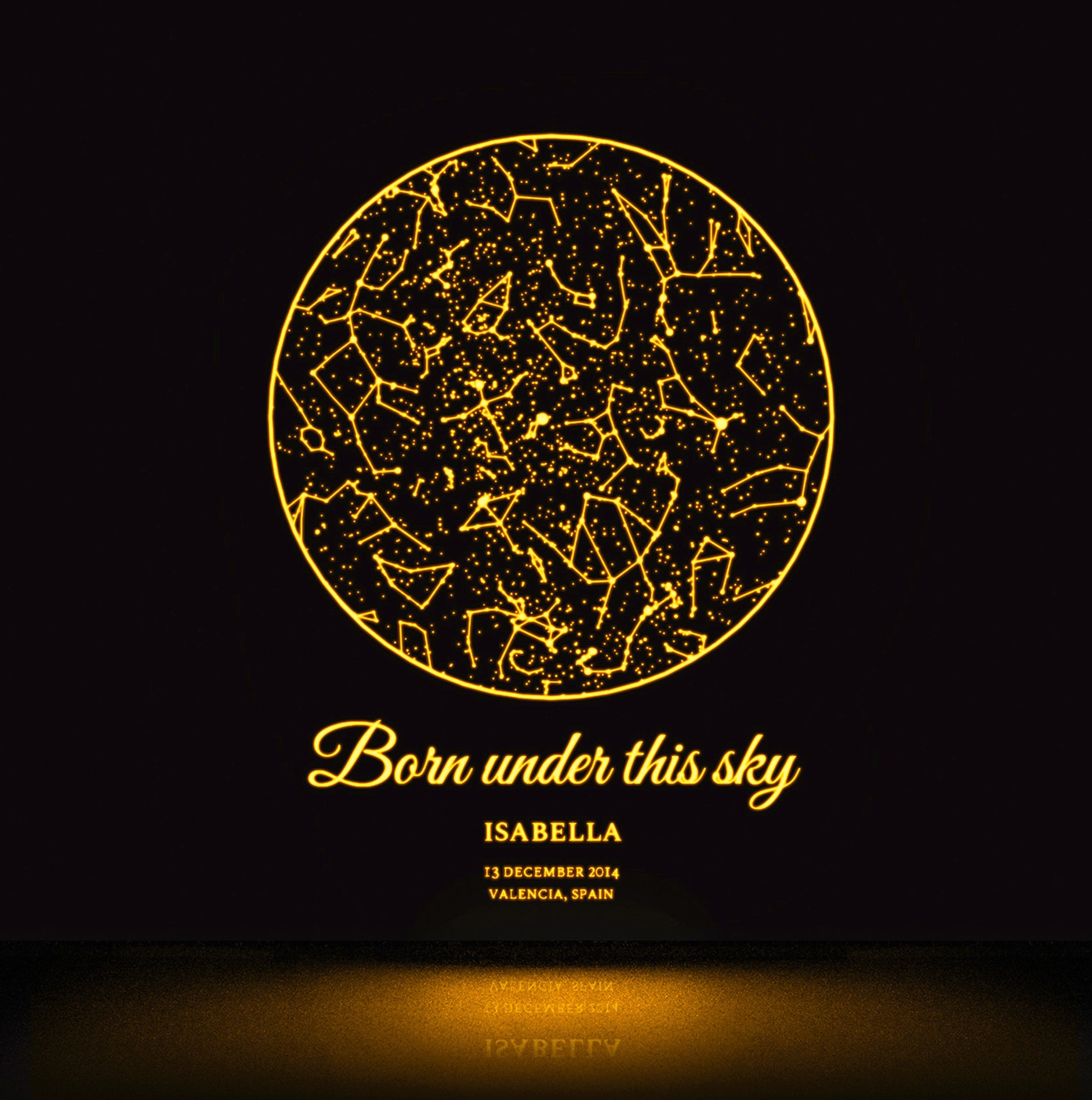 Personalized star map glowing in the dark with a yellow glow.