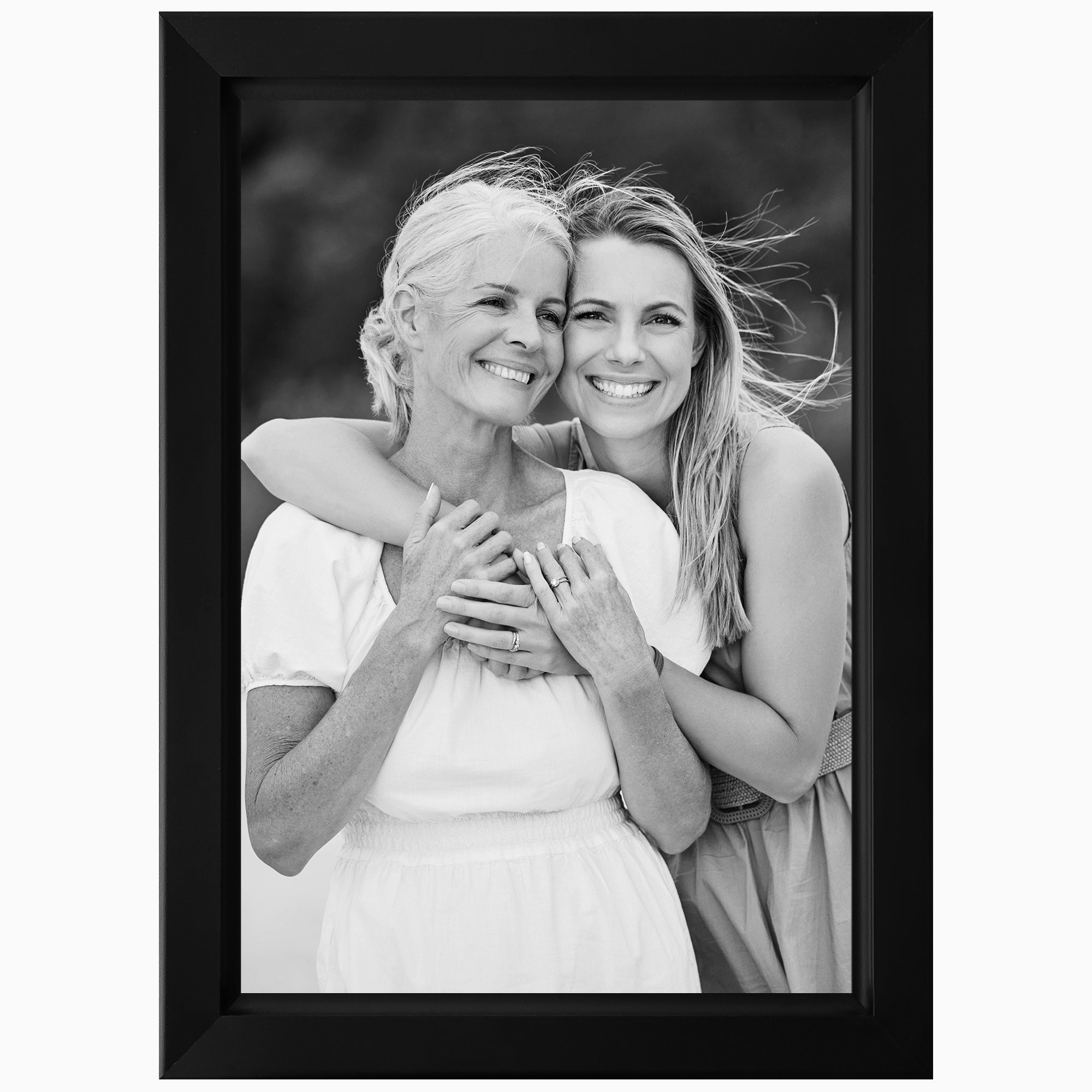 Two women embracing in a black frame